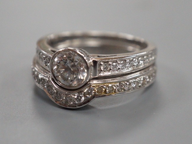 A modern 18ct white gold and collet set single stone diamond ring, with diamond set shoulders and 18ct and diamond set fitted wedding band, size J/K, gross weight 7.8 grams